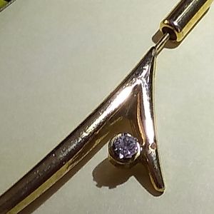 Pin gold color with white stone